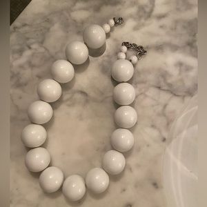 White lacquered oversized wooden beaded henri bendel necklace.